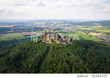 Hohenzollern Castle on forested mountain top in the Swabian Alps in summer Hohenzollern Castle on forested mountain top in the Swabian Alps in summer 92408370