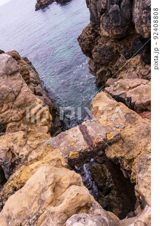 Rocks over blue ocean water Rocks over blue ocean water 92408808