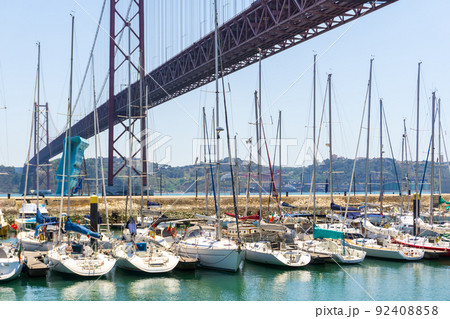 Berth with yachts under the Lisbon bridge April 25 92408858