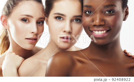three different nation woman: african-american, caucasian together isolated on white background happy smiling, diverse type on skin, lifestyle real people concept close up three different nation woman: african-american, caucasian together isolated on white background happy smiling, diverse type on skin, lifestyle real people concept close up 92408922