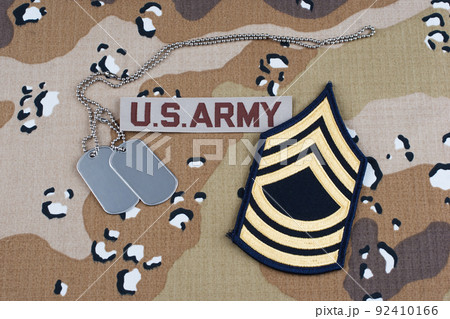 US ARMY Master Sergeant rank patch and dog tags on Desert Battle Dress Uniform background US ARMY Master Sergeant rank patch and dog tags on Desert Battle Dress Uniform background 92410166