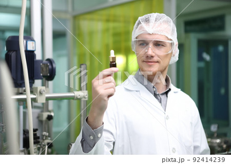 scientist  analyzing a biological and ecological hemp plant used for herbal pharmaceutical CBD oil and THC oil in a laboratory. 92414239