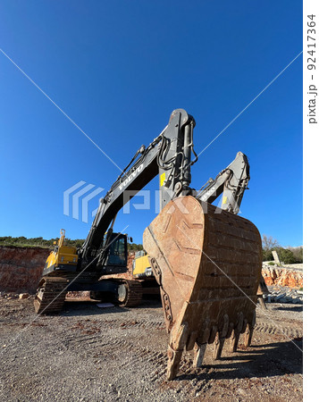 Caterpillar bulldozer with a huge bucket stands near a quarry Caterpillar bulldozer with a huge bucket stands near a quarry 92417364