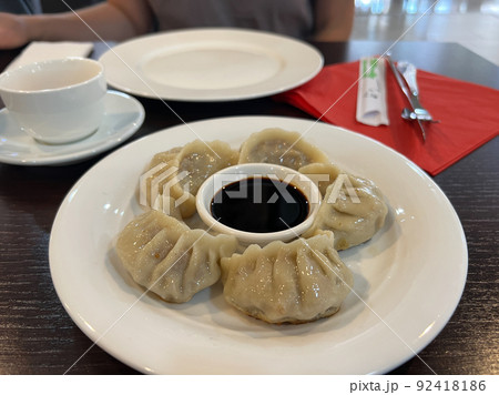 Plate of jiaozi and soy sauce is on the table Plate of jiaozi and soy sauce is on the table 92418186