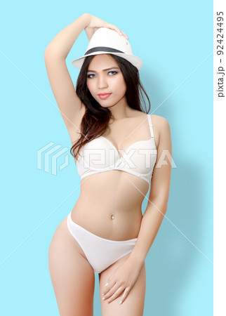 close up image of young asian woman with white bikini and blue background in studio close up image of young asian woman with white bikini and blue background in studio 92424495