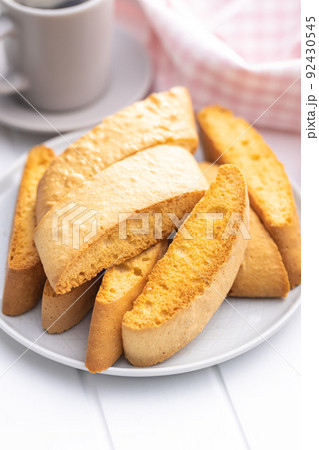 Sweet anicini cookies on plate. Italian biscotti with anise flavor on white table. 92430545
