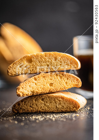 Sweet anicini cookies. Italian biscotti with anise flavor on black table Sweet anicini cookies. Italian biscotti with anise flavor on black table 92430563