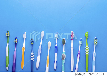 Toothbrushes on blue background. Space for text. Top view. 92434651