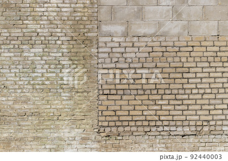 an old brick wall made of a large number of different types of bricks 92440003