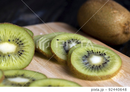sliced green kiwi fruit on a wooden board sliced green kiwi fruit on a wooden board 92440648