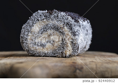 chocolate roll with a creamy curd layer in coconut chips chocolate roll with a creamy curd layer in coconut chips 92440912