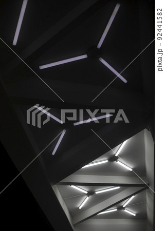 Light design. Fluorescent lamps on ceiling. Triangles of lamps. Interior details. 92441582