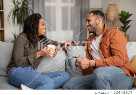 Loving African American Spouses Drinking Coffee And Talking At Home 92443874