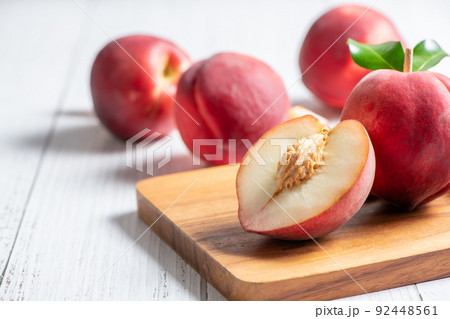 Fresh  peaches on wood plate and white background. 92448561
