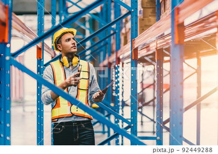 engineer male checking steel metal construction warehouse shelves structure building 92449288