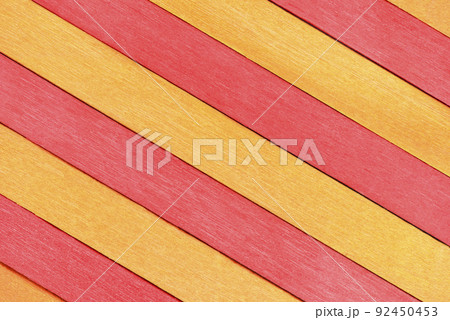 The surface of alternating red and orange wooden planks arranged diagonally. The surface of alternating red and orange wooden planks arranged diagonally. 92450453