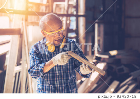 Senior Carpenter man Wood worker working hand made furniture in shop factory industry. male wooden craftsman builder working in workshop. Senior Carpenter man Wood worker working hand made furniture in shop factory industry. male wooden craftsman builder working in workshop. 92450718