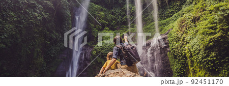 Dad and son at the Sekumpul waterfalls in jungles on Bali island, Indonesia. Bali Travel Concept BANNER, LONG FORMAT Dad and son at the Sekumpul waterfalls in jungles on Bali island, Indonesia. Bali Travel Concept BANNER, LONG FORMAT 92451170