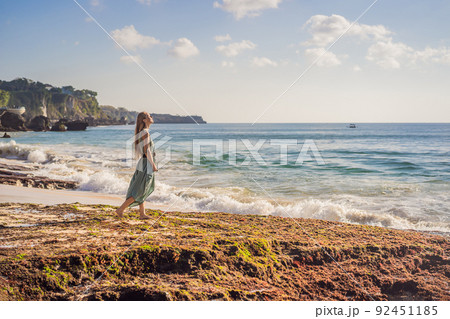 Young woman tourist on Pantai Tegal Wangi Beach, Bali Island, Indonesia. Bali Travel Concept 92451185