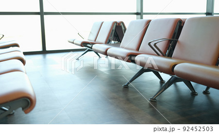 Location in airport terminal. Leather light brown armchairs at station station 92452503