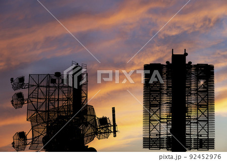 Air defense radars of military mobile anti aircraft systems (radar is designed and automatic tracking of targets and missiles) , on the background of the sunset orange sky, Russia Air defense radars of military mobile anti aircraft systems (radar is designed and automatic tracking of targets and missiles) , on the background of the sunset orange sky, Russia 92452976