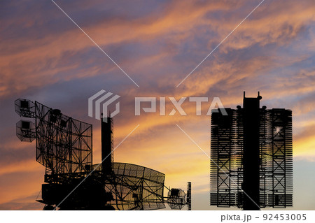 Air defense radars of military mobile anti aircraft systems (radar is designed and automatic tracking of targets and missiles) , on the background of the sunset orange sky, Russia Air defense radars of military mobile anti aircraft systems (radar is designed and automatic tracking of targets and missiles) , on the background of the sunset orange sky, Russia 92453005