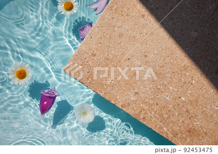 Product promotion Beauty cosmetic showcase. Travertine stone display with flowers in water. Product promotion Beauty cosmetic showcase. Travertine stone display with flowers in water. 92453475