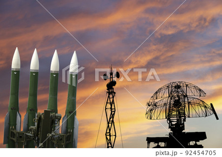 Air defense radars of military mobile anti aircraft systems and modern Russian anti-aircraft missiles OSA-AKM on the background of the sunset orange sky,Russia 92454705