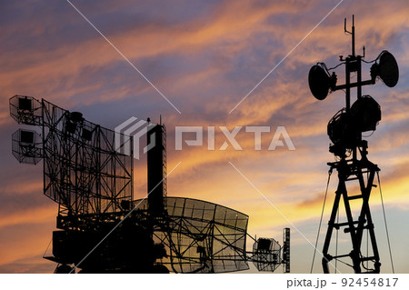 Air defense radars of military mobile anti aircraft systems, modern army industry on the background of the sunset orange sky, Russia Air defense radars of military mobile anti aircraft systems, modern army industry on the background of the sunset orange sky, Russia 92454817