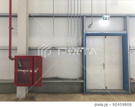 Fire extinguisher box with fire hose inside and emergency exit Fire extinguisher box with fire hose inside and emergency exit 92459608