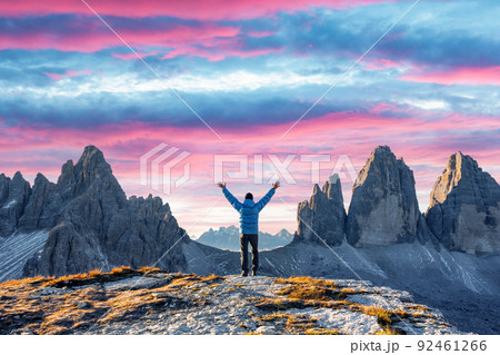 Tourist in blue jacket at Three Peaks of Lavaredo track on autumn season Tourist in blue jacket at Three Peaks of Lavaredo track on autumn season 92461266