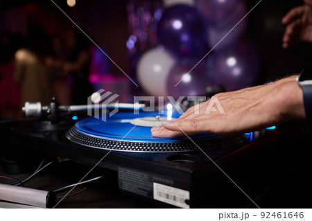 DJ behind the decks in a nightclub. DJ spinning plate. people dancing in a nightclub. disco. DJ behind the decks in a nightclub. DJ spinning plate. people dancing in a nightclub. disco. 92461646