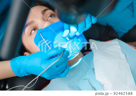 Closeup shot of a female patient with a cofferdam system in a modern dental office. Dental equipment 92462588