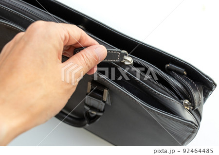 黒いバッグのジッパーを開ける 92464485