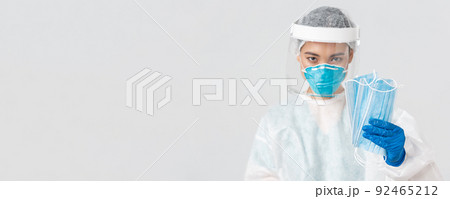 Covid-19, coronavirus disease, healthcare workers concept. Confident serious-looking female asian doctor in personal protective equipment insist patient wearing medical masks, white background Covid-19, coronavirus disease, healthcare workers concept. Confident serious-looking female asian doctor in personal protective equipment insist patient wearing medical masks, white background 92465212