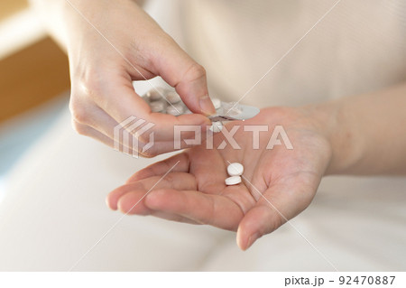薬を飲む若い女性　ボディパーツ　パーツカット 92470887