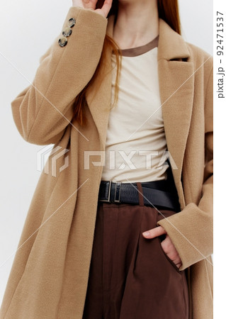 Clothing details for clothing brands. Catalog photography in brown tones on a white background in the studio 92471537
