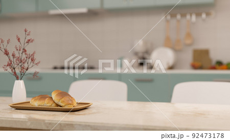Modern marble dining tabletop with copy space over blurred minimal home kitchen cooking space Modern marble dining tabletop with copy space over blurred minimal home kitchen cooking space 92473178