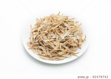 dried small crispy fish on white background dried small crispy fish on white background 92479742