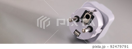 White electrical plug on gray background. Electrical safety White electrical plug on gray background. Electrical safety 92479791