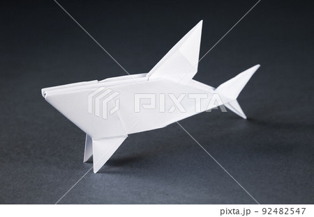 White paper shark origami isolated on a grey background 92482547