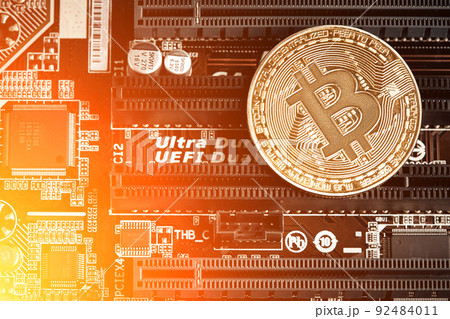 Bitcoin. New virtual money. Bitcoins lie on the video card, concept of mining. Sun flare Bitcoin. New virtual money. Bitcoins lie on the video card, concept of mining. Sun flare 92484011