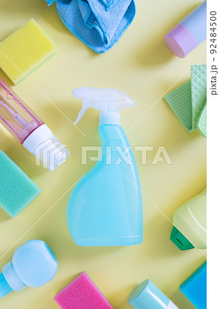 Cleaning concept - cleaning supplies on pastel yellow background Cleaning concept - cleaning supplies on pastel yellow background 92484500