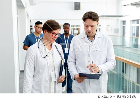 Doctors Walking in Clinic Doctors Walking in Clinic 92485136