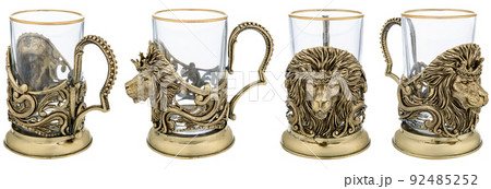 Metal brass Lion Animal cup holder with empty glass. Close up Three views isolated on white background. used for hot tea or coffee on trains. Vintage decorative souvenir. 92485252