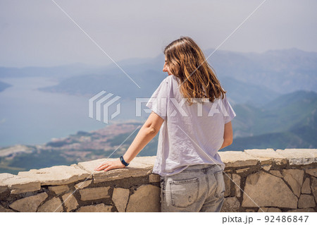 Woman tourist enjoys the view of Kotor. Montenegro. Bay of Kotor, Gulf of Kotor, Boka Kotorska and walled old city. Travel to Montenegro concept. Fortifications of Kotor is on UNESCO World Heritage Woman tourist enjoys the view of Kotor. Montenegro. Bay of Kotor, Gulf of Kotor, Boka Kotorska and walled old city. Travel to Montenegro concept. Fortifications of Kotor is on UNESCO World Heritage 92486847