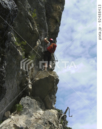 Climber at Postalmklamm via ferrata in Austria Climber at Postalmklamm via ferrata in Austria 92488413