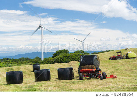 風車と夏の空の下の牧草刈りの風景 風車と夏の空の下の牧草刈りの風景 92488954