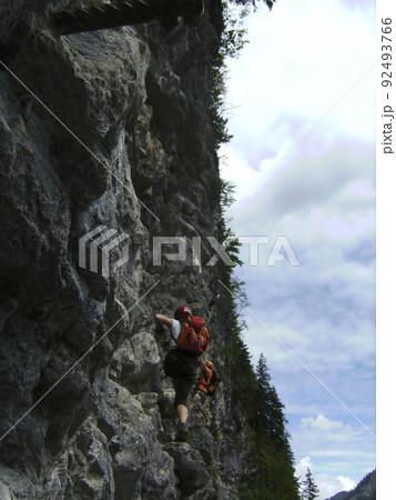 Climber at Postalmklamm via ferrata in Austria Climber at Postalmklamm via ferrata in Austria 92493766