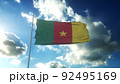 Flag of Cameroon waving at wind against beautiful blue sky. 3d illustration 92495169